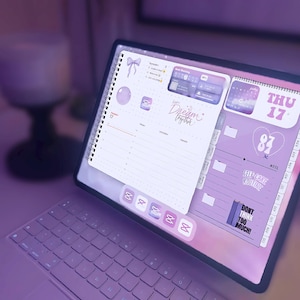 May include: A digital planner with a spiral binding, open to a page with a purple and white design. The planner displays the date, Thursday the 17th, and includes the text "Dream Together" and "Self-Care Routine."