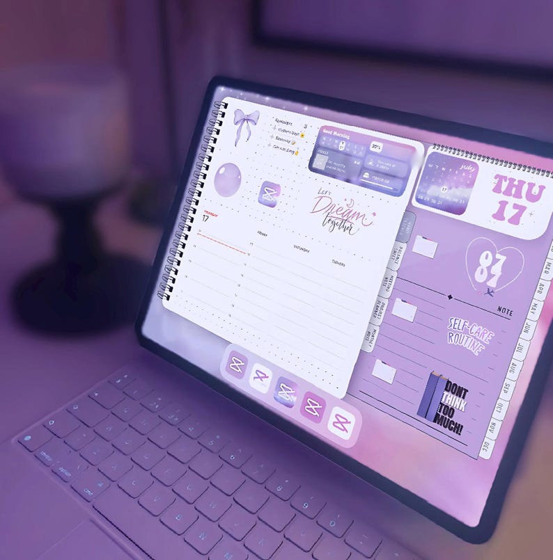May include: A digital planner with a spiral binding, open to a page with a purple and white design. The planner displays the date, Thursday the 17th, and includes the text "Dream Together" and "Self-Care Routine."