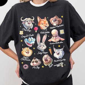 May include: Black graphic t-shirt featuring cartoon characters from Zootopia, including Chief Bogo, Nick Wilde, and Judy Hopps. The shirt has a crew neck and short sleeves. The word "Black" is in a black circle in the upper left corner.