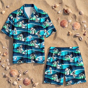 May include: A short-sleeve button-down shirt and matching shorts set featuring a repeating pattern of the character Olaf from Frozen, palm trees, and a sunset over ocean waves in shades of blue, teal, and white on a dark navy background.