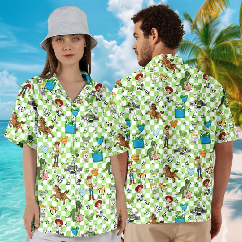 May include: Green and white checkered button-down shirt featuring cartoon characters. The shirt has short sleeves and a classic collar. The design includes various characters and star shapes. The shirt is worn by two people.