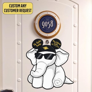 May include: A white elephant cartoon character wearing sunglasses and a black hat with a gold emblem. Above, a circular sign displays the number 9058. Text on the sign reads "CUSTOM ANY CUSTOMER REQUEST". Additional text includes "The Smith Family" and "Fast Disney Cruise Oct 9-12, 2026".