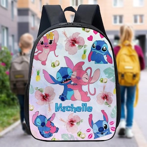 May include: Black backpack with a vibrant design of cartoon characters, hibiscus flowers, and pineapples. The backpack has the name "Michelle" in blue. The design features pink and blue characters with large eyes and ears.