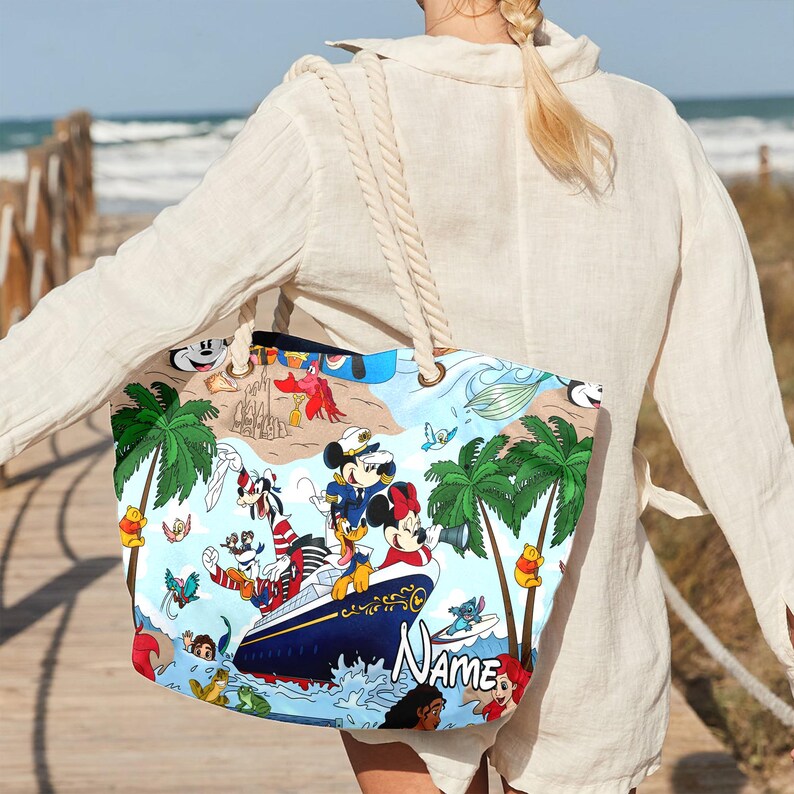 May include: A colorful tote bag with a nautical theme featuring Mickey Mouse and other Disney characters. The bag has a blue and white striped design with palm trees and a cruise ship. The text "Name" is printed on the bag.