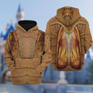 May include: Brown hooded sweatshirt with an insect-like design. The front has a chest plate design, and the back shows a detailed insect head and wing pattern. The hoodie has a black interior and a full-zip closure.