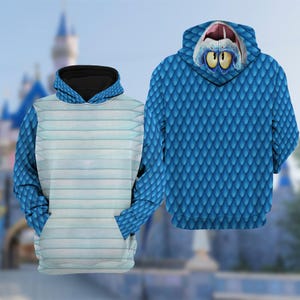 May include: Two hooded sweatshirts. One has a blue scale pattern, the other has a light blue and white striped pattern. The blue scale sweatshirt has a monster face on the hood. Both sweatshirts have front pockets.