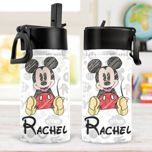 May include: Two white water bottles with black lids and handles. Each bottle features a sketch of Mickey Mouse in black, red, and yellow. The name "Rachel" is printed in black script below the character.