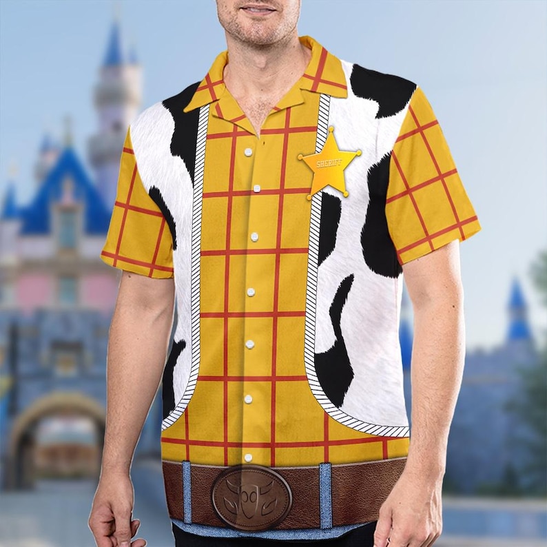 May include: A yellow and red checked short-sleeved button-up shirt with a white and black cow print waistcoat, a brown belt with a silver buckle, and a yellow sheriff's star badge.