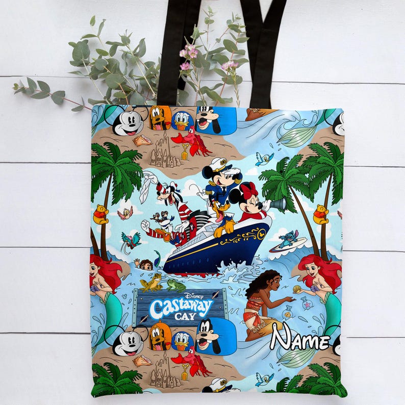 May include: A blue and white tote bag with a Disney Castaway Cay theme. The bag features Mickey Mouse, Minnie Mouse, Goofy, Donald Duck, and other Disney characters. The bag also features a ship, palm trees, and the words "Disney Castaway Cay".
