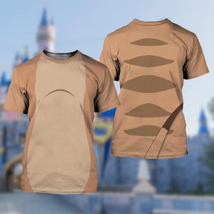 May include: Two short-sleeved t-shirts featuring a tan and brown animal-inspired pattern. The left shirt displays a light tan central panel with a curved line, while the right shirt shows a series of horizontal brown ovals and a diagonal stripe.