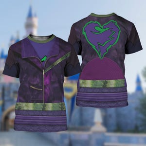 May include: Two short-sleeved t-shirts with a purple and green design. One shirt features a purple jacket design with a zipper and green accents. The other shirt has a heart-shaped graphic with a green outline and a purple center.