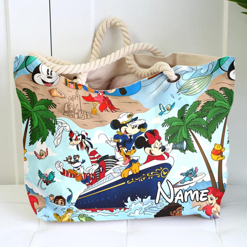 May include: A large canvas tote bag with a nautical theme featuring Mickey Mouse, Minnie Mouse, Goofy, Donald Duck, and Stitch. The bag has a rope handle and a blue and white design with the text "Name" on the bottom.