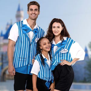 May include: A family of three wearing blue and white striped vests with a white shirt and black shorts. The vests have a blue bow tie and a name tag that says "Cast Member".