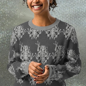 May include: A gray sweatshirt with a white frog pattern. The frog pattern is repeated all over the sweatshirt.