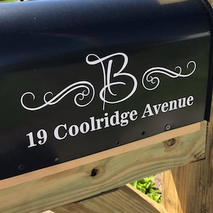 May include: Black mailbox with a white cursive letter "B" and the address "19 Coolidge Avenue" in white lettering.