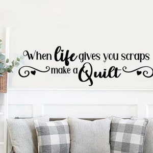 May include: Black and white vinyl wall decal with the text "When life gives you scraps make a quilt" with two small hearts on either side of the text.