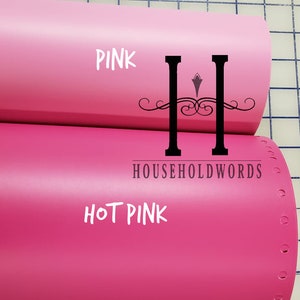 May include: Two rolls of vinyl adhesive film, one pink and one hot pink. The rolls are labelled "PINK" and "HOT PINK" with the text "HOUSEHOLDWORDS" printed on the bottom roll.
