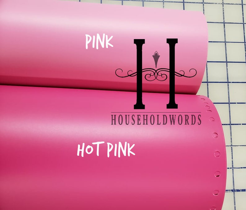 May include: Two rolls of vinyl adhesive film, one pink and one hot pink. The rolls are labelled "PINK" and "HOT PINK" with the text "HOUSEHOLDWORDS" printed on the bottom roll.