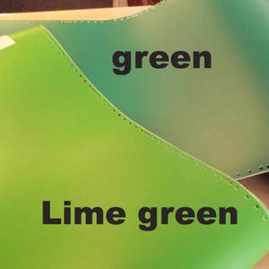 May include: Two pieces of leather in different shades of green. The top piece is a darker green and labeled "green". The bottom piece is a lighter green and labeled "Lime green".