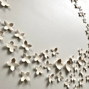 Close up of porcelain ceramic wall art. Some pieces are smaller and three are larger.