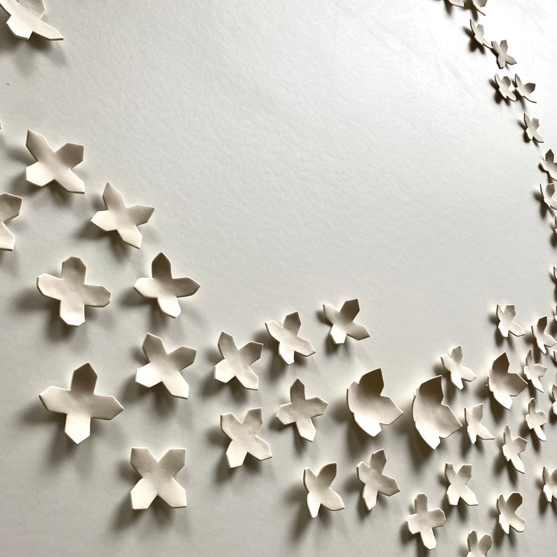 Close up of porcelain ceramic wall art. Some pieces are smaller and three are larger.