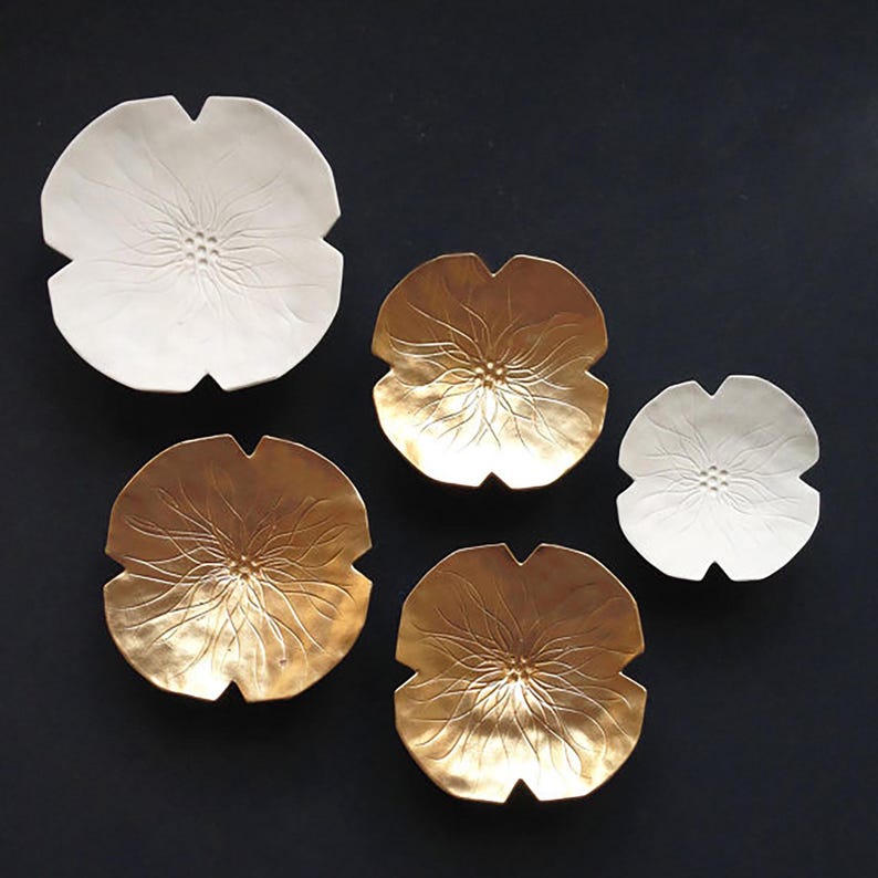 Set of 5 original ceramic flowers designed for interior decoration. 2 flowers are finished plain porcelain and 3 are finished in metallic gold.