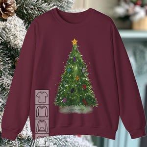 May include: Burgundy sweatshirt with a Christmas tree design featuring a variety of colorful ornaments. The tree is decorated with bugs and the text "<jingle_bugs>" is printed below the tree.