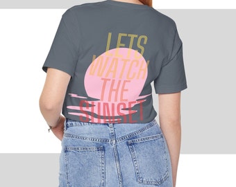 May include: A gray t-shirt with a pink and yellow graphic that says "Let's watch the sunset".