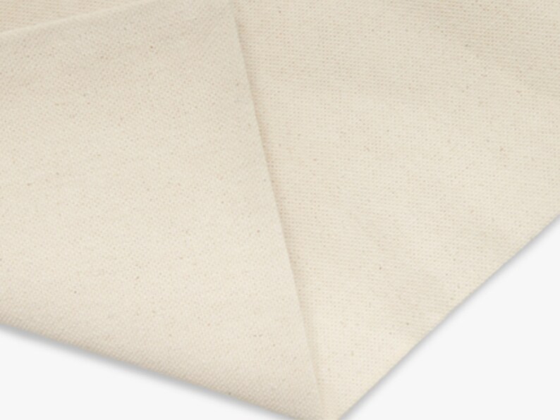 A blank canvas tote bag with flat corners and sturdy handles. Made of durable cotton in a natural color, it's perfect for carrying everyday items. A blank cotton canvas tote bag with sturdy handles.