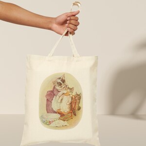 Mama Bag Tabitha Twitchit Tote Featuring Tom Kitten and Miss Moppet Cotton Canvas Tote Bag."Beatrix Potter Tabitha Twitchit Tote Bag featuring a vintage-style illustration of Tabitha Twitchit, the beloved mother cat from Tom Kitten’s story. Eco-friendly cotton tote with sturdy handles, perfect for book lovers, nursery decor, or everyday use. A charming gift for Beatrix Potter fans and collectors: Study handle
