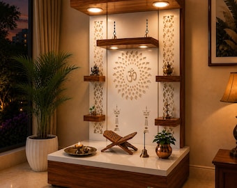 May include: A wooden home temple unit featuring a white back panel with a laser-cut Om symbol and floral mandala design. The structure includes integrated LED lighting, multiple shelves for decorative items, a central book stand, and a brass bell.