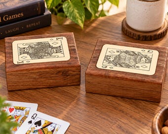 May include: Two rectangular wooden boxes with hinged lids, each featuring a light-colored inlay on top. One box displays a black line-art illustration of a King of Diamonds playing card, while the other shows a Queen of Diamonds playing card.