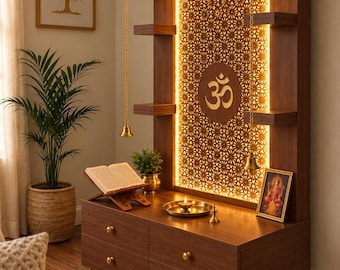 May include: A dark wood home temple unit featuring a central backlit panel with a gold Om symbol and intricate geometric cutouts. The structure includes four drawers, side shelves, and a row of hanging brass bells along the top edge.