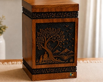 May include: A rectangular wooden cremation urn featuring a dark brown finish with a carved relief panel on the front. The carving depicts a person sitting on a bench with a dog under a tree with a heart-shaped canopy, mountains, and birds.