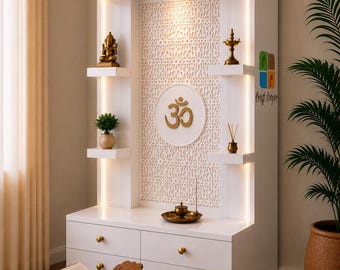 May include: A white wooden home temple unit featuring four shelves, two drawers with gold knobs, and integrated LED lighting. The central panel displays a gold Om symbol against a laser-cut geometric backdrop. A wooden book stand sits in front.