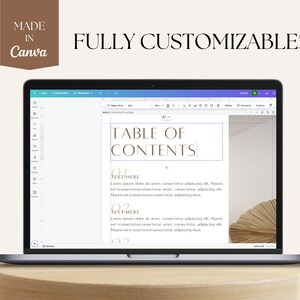 May include: A laptop screen displaying a Canva document with a table of contents. The document has a light brown background and the text "TABLE OF CONTENTS" is in a brown font. The document also includes the text "TEXT HERE" and "01" in a brown font.