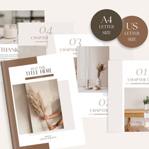 May include: A book cover mockup with a brown background and a white title that says "PUT THE TITLE HERE". The book cover features a photo of a hand holding a dried pampas grass. The text "BOOK BY OLIVIA WILSON" is at the bottom of the cover. There are four additional pages with chapter titles and numbers, including "Chapter One", "Chapter Two", "Chapter Three", and "Chapter Four". The pages are in A4 and US letter sizes.