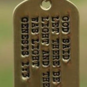 May include: Gold chain with a gold dog tag pendant that reads "God said let there be light and there was light" Genesis 1:3.