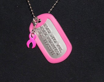May include: A pink dog tag necklace with a silver chain and a pink ribbon charm. The dog tag has the text "Forever with you, Never Forgotten, R.I.P. 11/22/11".