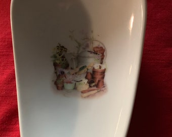 Ceramic Spoon Rest with Gardening  on it.  5" Long And 3 1 1/2 Wide at Top of Spoon