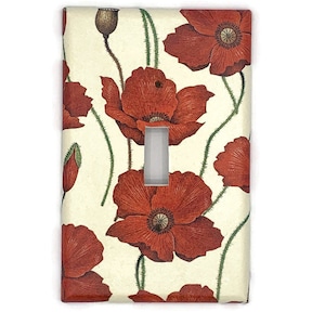 May include: A white light switch cover with a red poppy floral pattern. The switch cover is rectangular and has a single switch opening.