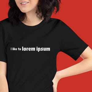 May include: A black t-shirt with white text that reads "I like to lorem ipsum".