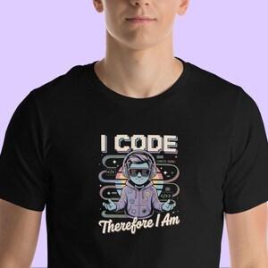 May include: Black t-shirt featuring a cartoon character wearing headphones and the text "I CODE Therefore I Am".