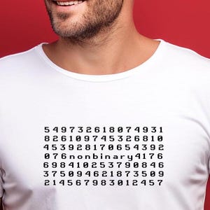 May include: White t-shirt with a black graphic of a series of numbers, including the text "nonbinary".