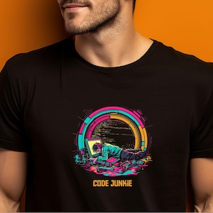 May include: Black t-shirt featuring a graphic of a person working on a computer with the text "CODE JUNKIE" underneath.