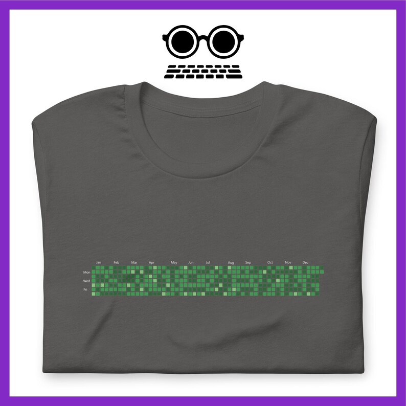 Może przedstawiać: Ciemnoszary t-shirt z zielonym pikselowym wzorem kalendarza. Kalendarz pokazuje dni tygodnia i miesiące roku.
