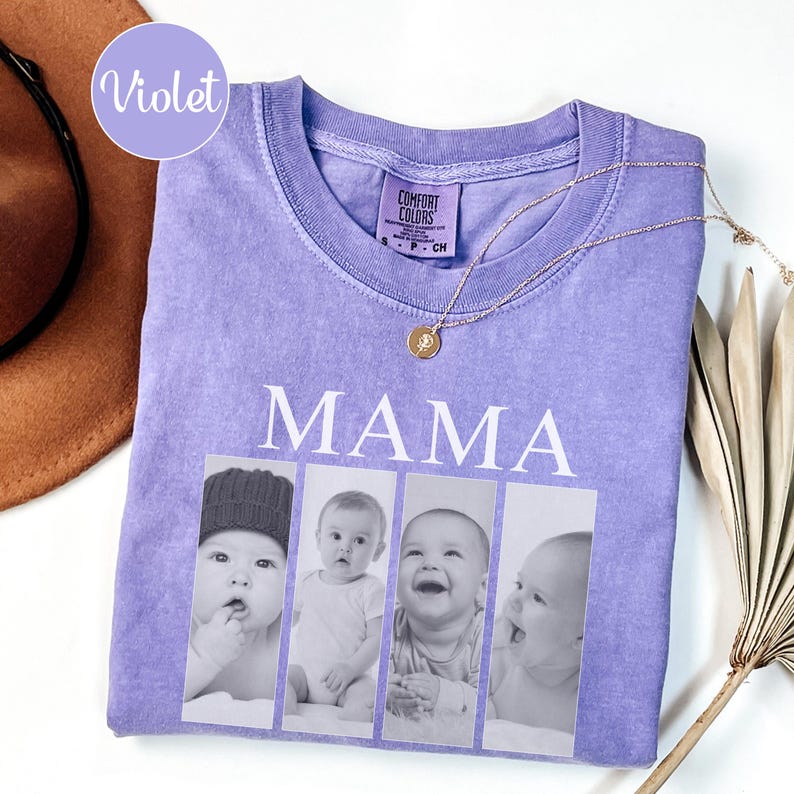 May include: A violet short-sleeved t-shirt featuring the word MAMA in white capital letters above four vertical black and white photographic panels showing a baby in different poses. The shirt has a Comfort Colors brand label at the inner neckline.