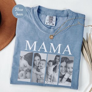 May include: A blue jean colored t-shirt with a crew neckline and a Comfort Colors brand label. The shirt features the word MAMA in large white capital letters above four vertical black and white photographic panels showing a parent and child.