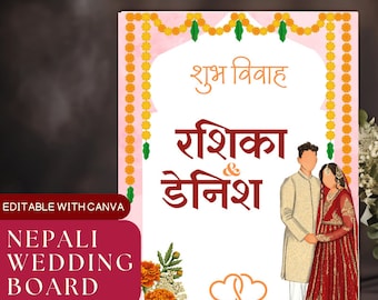 May include: A pink and white wedding sign with a floral garland border. The sign says "Shubh Vivah" in orange text, followed by "Rashika & Denish" in red text. The date "26-06-2026" is written in orange text below the couple's names. Two orange hearts are above the date. A cartoon illustration of a couple in traditional clothing is on the right side of the sign.