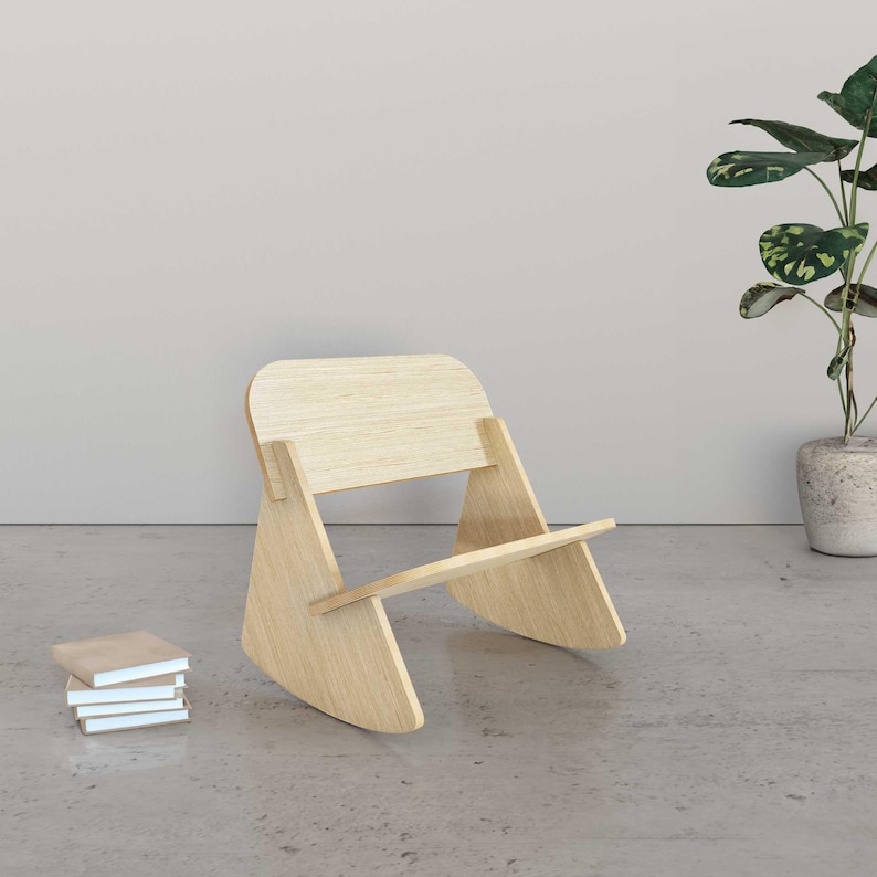 May include: A light wood rocking chair with a curved back and a flat seat. The chair is made of natural wood and has a simple, modern design.